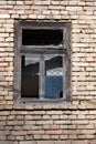 Detail of old broken window on brick wall Royalty Free Stock Photo