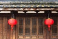 Detail of old Chinese style building with wooden door and windows and red lantern Royalty Free Stock Photo