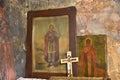 Detail from an old Christian church - The cross and icons of Saints on the ancient wall of the Orthodox temple.