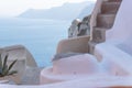 Detail of old church dome with blurred Greek building with stairs and seascape, Oia, Santorini, Greece Royalty Free Stock Photo