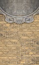 Detail of an old classic carved stone frame against a brick wall - concept with copy space Royalty Free Stock Photo