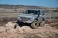 classic Japanese SUV Nissan Patrol of third generation of gray color in a stone area