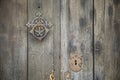 Detail of old dark wooden door with metal knocker and lock Royalty Free Stock Photo