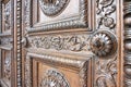 Detail of an old italian wooden carved door with floral decorati