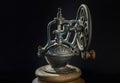 Detail of Old original coffee grinder metal shake wheel with hand crank on dark background Royalty Free Stock Photo