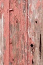 Detail of old, peeling red paint on small, wood out building background Royalty Free Stock Photo