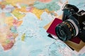 Detail of old photo camera and a passport on a world map. Adventure travel concept. Copy-space Royalty Free Stock Photo