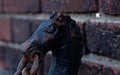 detail from old railing of metal chain representing a horse\'s head Royalty Free Stock Photo