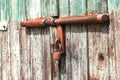 Detail of an old rusty latch with lock