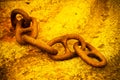 Detail of an old rusty metal chain anchored to a concrete block Royalty Free Stock Photo