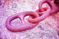 Detail of an old rusty metal chain anchored to a concrete block Royalty Free Stock Photo