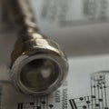 Detail of an old Silver Trumpet mouthpiece on sheet music book Royalty Free Stock Photo
