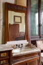 Detail old sink with mirror above in bedroom. Interior of an abandoned villa to be restored Royalty Free Stock Photo