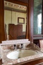 Detail old sink with mirror above in bedroom. Interior of an abandoned villa to be restored Royalty Free Stock Photo