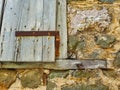 Detail of Old Stone House With Rough Wooden Window Shutter