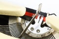 Detail of an old typewriter from the 1950s with ink ribbon and blank paper, one type hammer is pushed, close up Royalty Free Stock Photo