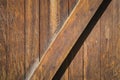 Detail of old unpainted wooden door with vertical slats and one diagonal slat. Royalty Free Stock Photo