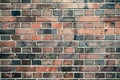 Detail of old and weathered grungy red and gray brick wall marked by the long exposure to the elements surface texture background Royalty Free Stock Photo