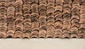 Detail of old weathered terracotta roof tiles