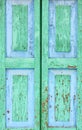 Detail of an old window. Peeling paint green and blue color on the wooden shutters. Royalty Free Stock Photo