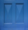 Detail of an old wooden blue painted door. Blue background. Blue rectangular frame