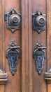 Detail of an old wooden door with bronze handles and locks Royalty Free Stock Photo