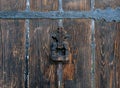 Detail of an old wooden door with an iron knocker