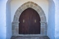 Detail an old wooden door of Muslim origin belonging to a chapel with a pointed arch. Concept church, religion, buildings,