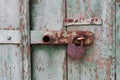Detail of old wooden door with rusty padlock Royalty Free Stock Photo