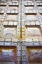 Detail of an old wooden doorway with metal nails reinforcement