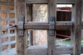 Detail of old wooden gate. Rusted iron gate bolt