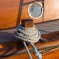 Detail of an old wooden sailing ship with rope and porthole Royalty Free Stock Photo