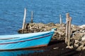 Detail of an old wooden traditional fishing boat in shallow water