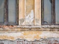 Detail with an old worn out building. Plaster peeling from an old brick wall in Bucharest, Romania Royalty Free Stock Photo