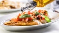 Detail of olive oil poured over bruschetta with basil and tomatoes Royalty Free Stock Photo