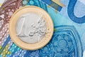 Detail of one Euro coin on blue banknote background Royalty Free Stock Photo