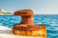 Detail of one iron rusty pier in a mediterrean harbor