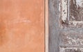 Detail of orange cement wall and wooden door texture background Royalty Free Stock Photo