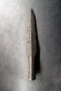 Detail of original prehistoric or medieval weapons - spear, used by tribes for hunting. Rustic iron weapon found by archeologists