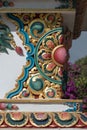 Nepal, Detail of ornamented corner of a tibetan buddhist stupa with bougainvillea flowers in the background. Royalty Free Stock Photo