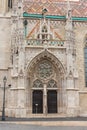 Detail of an ornate Victorian brick archway and wooden door a church. Royalty Free Stock Photo