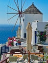 Outdoor Cafe and Traditional Windmill, Oia, Santorini, Greece Royalty Free Stock Photo