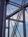 Detail of painted riveted bridge against blue sky. Royalty Free Stock Photo