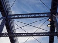 Detail of painted riveted bridge against blue sky. Royalty Free Stock Photo