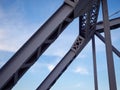 Detail of painted riveted bridge against blue sky. Royalty Free Stock Photo