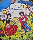 detail of a painting of a couple of boys dancing of Sicilian handicraft production