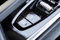 Detail of a parking brake in a modern car. Electronic parking brake button in a modern car. Button closeup Royalty Free Stock Photo