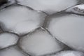 Irregular ice floes floating on water surface.