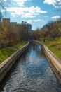 Detail of Pavia River in Viseu, Portugal, with water, green trees and a blue sky with clouds Royalty Free Stock Photo