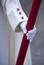 Detail penitent red holding a candle during Holy Week